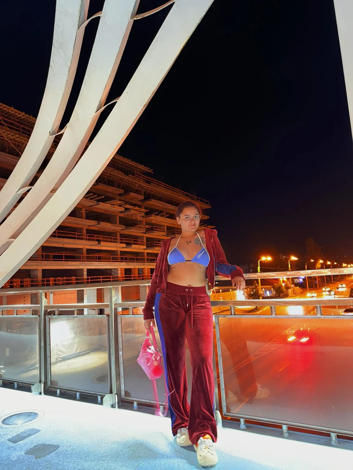 Andreea in a burgundy outfit at night