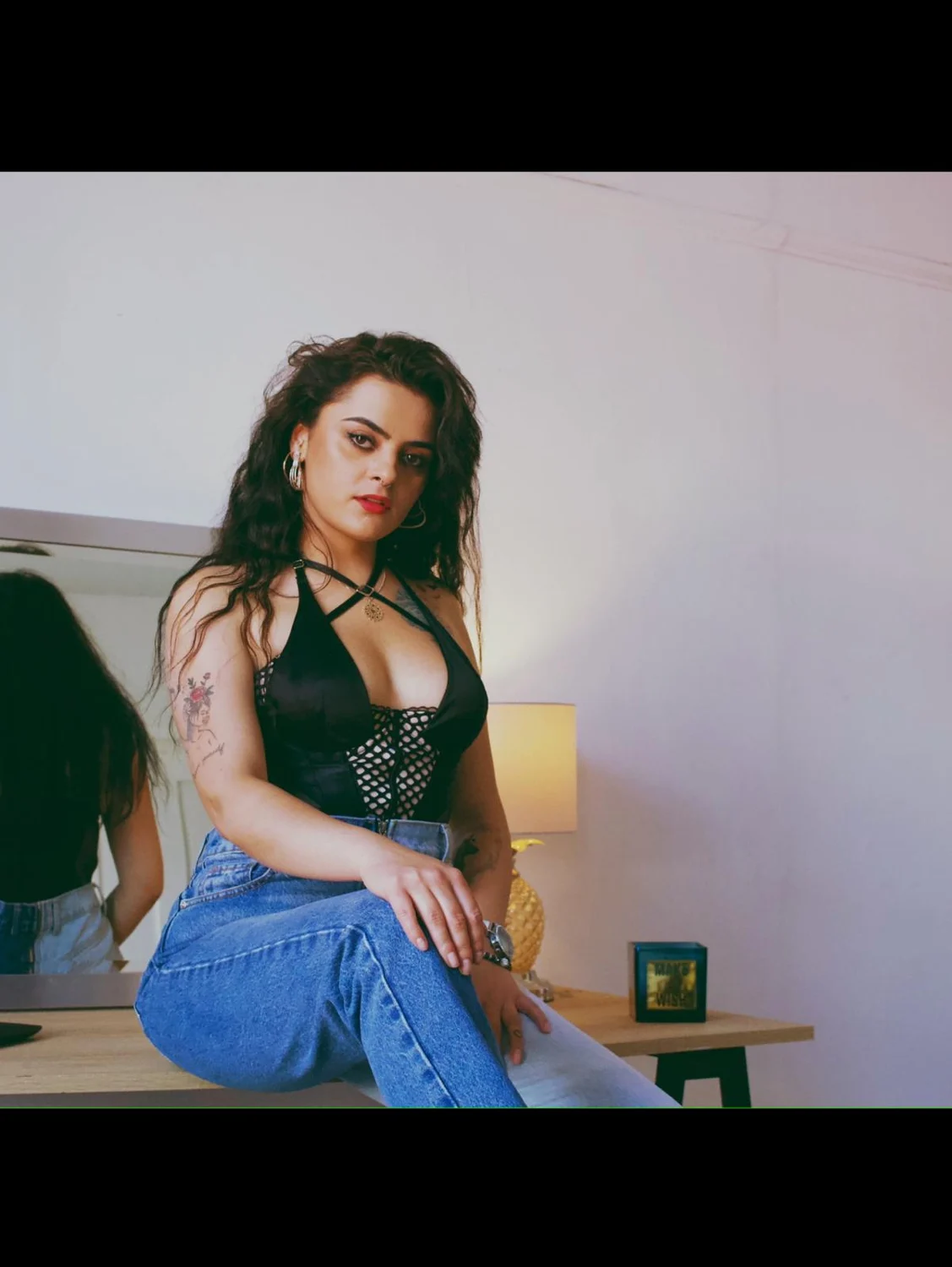 Andreea sitting beside a mirror