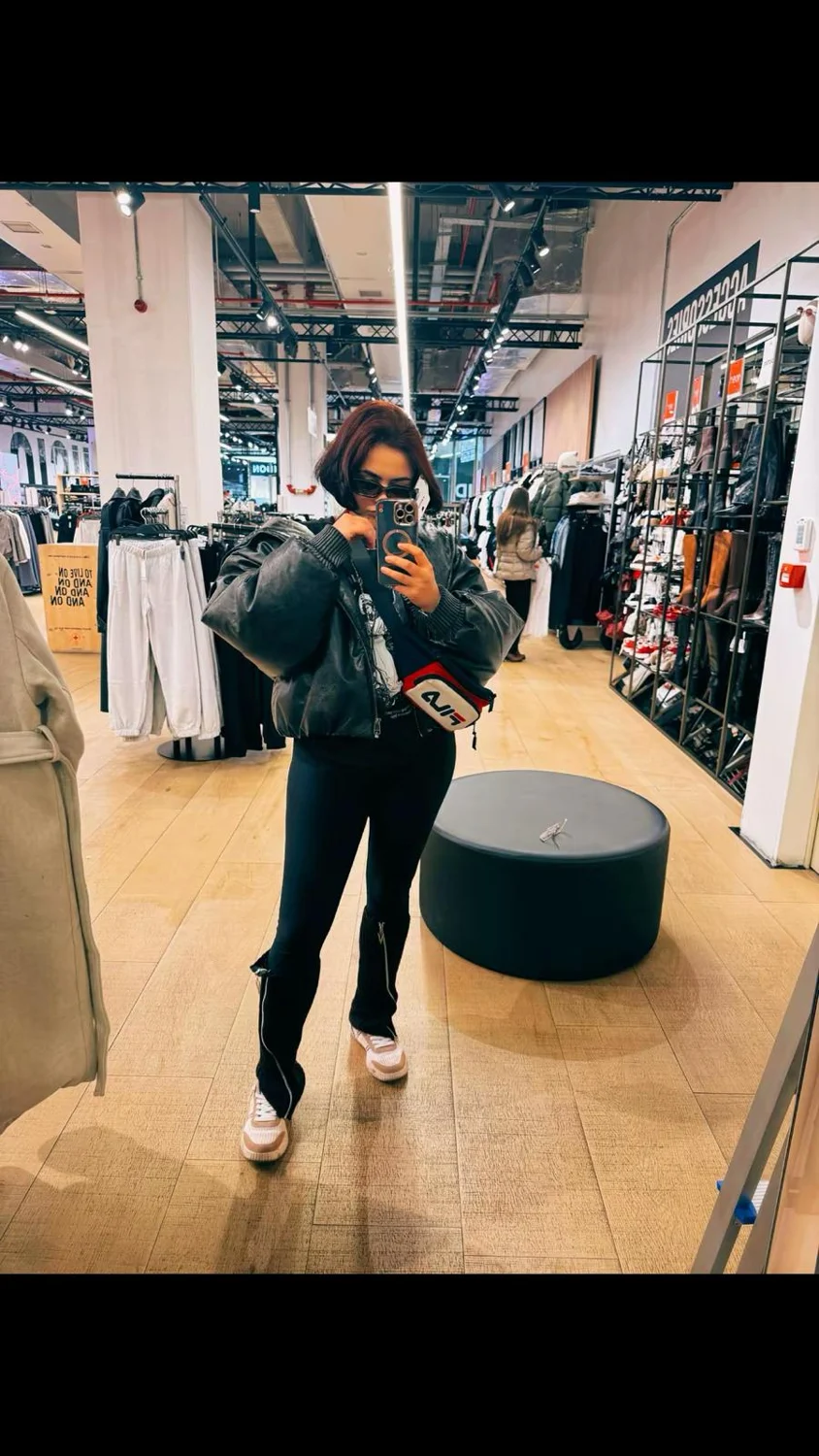 Andreea in a shop mirror