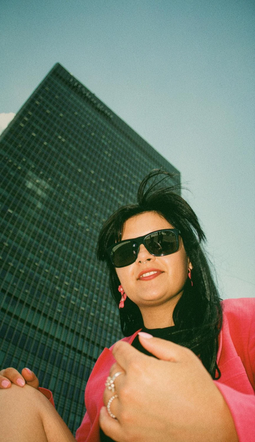 Andreea in a pink blazer and sunglasses