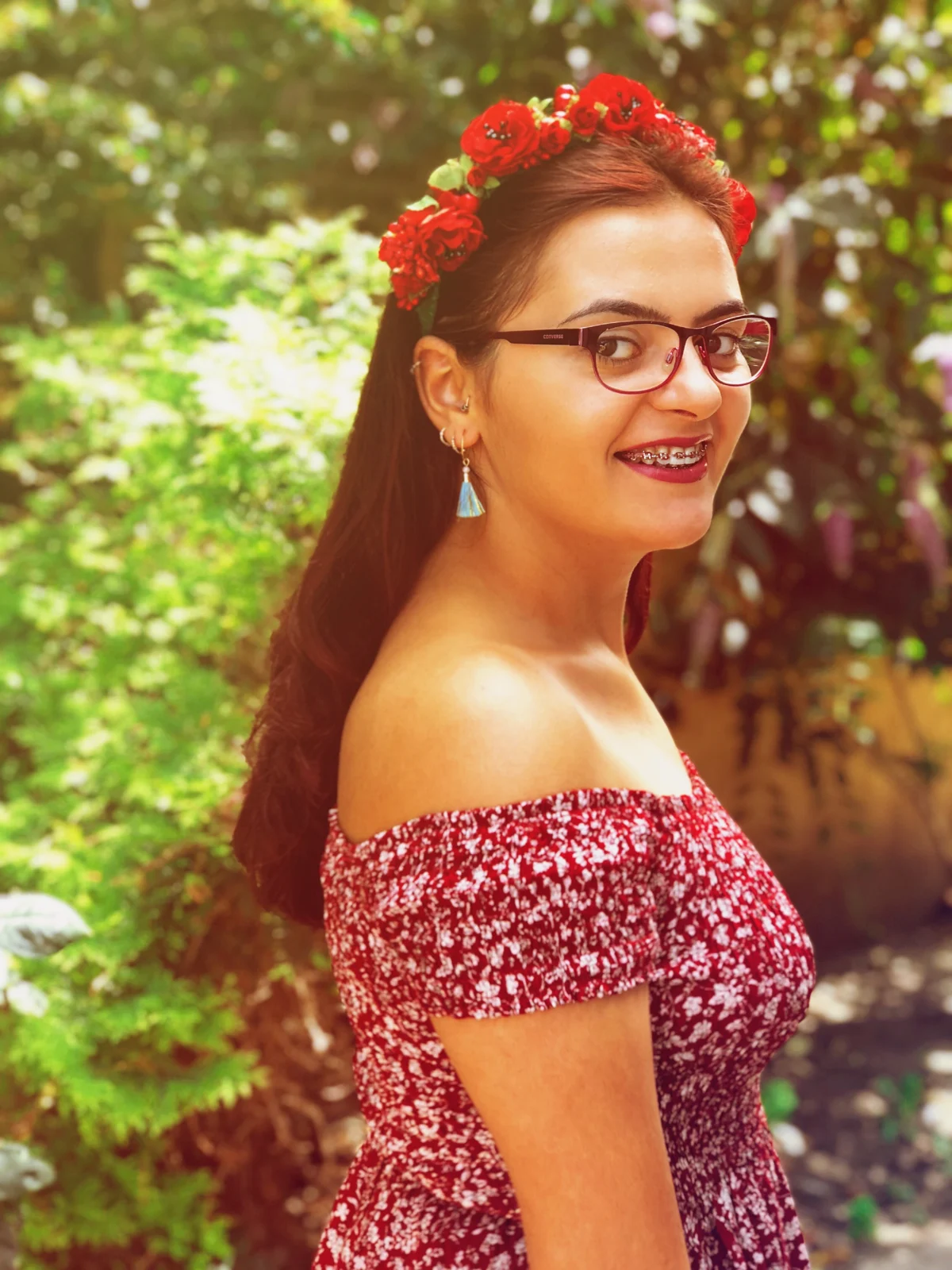 A red flower crown among the trees