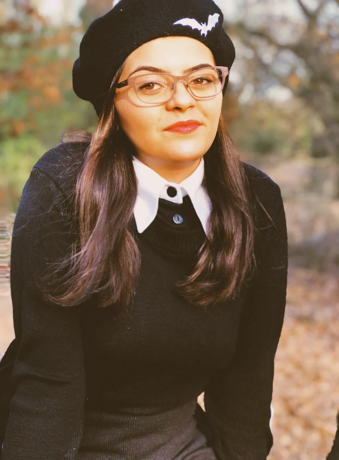 A black beret with a little bat