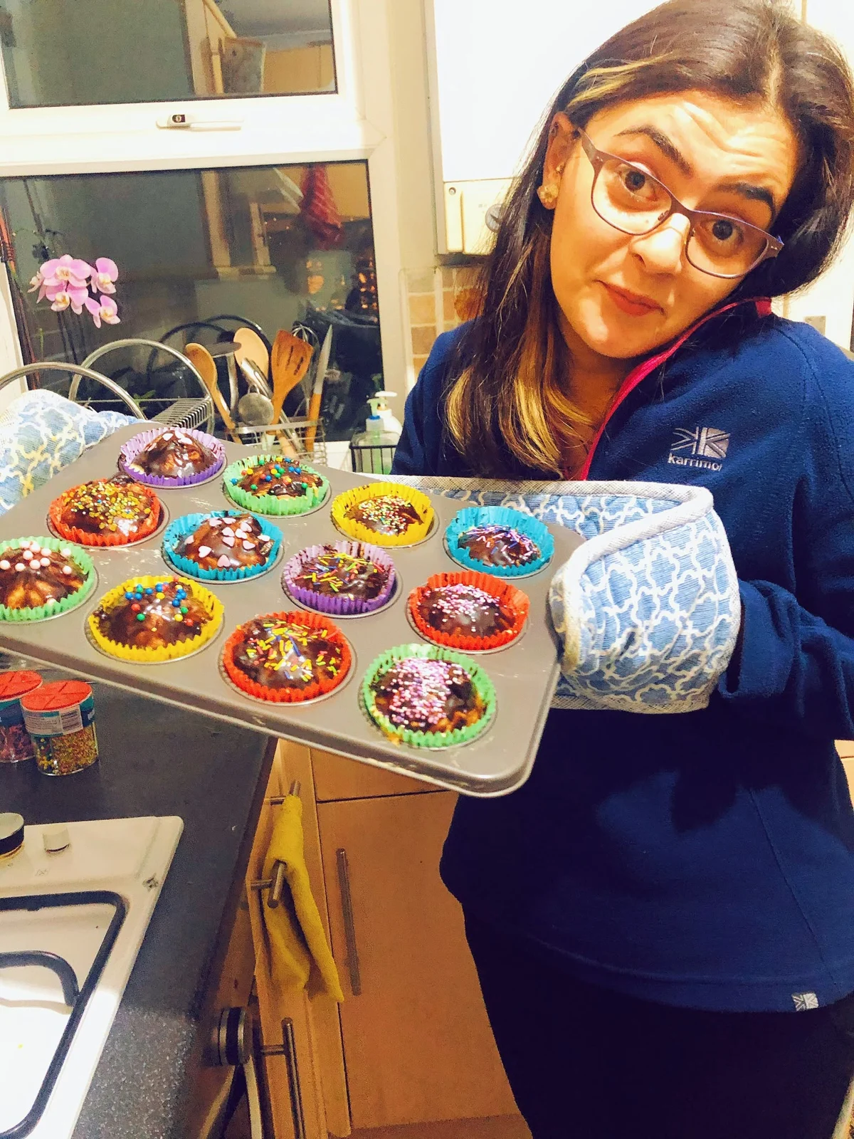 A tray of colourful cupcakes